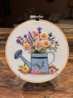 Hand embroidered 5” colorful watering can full of flowers. Stand not included.